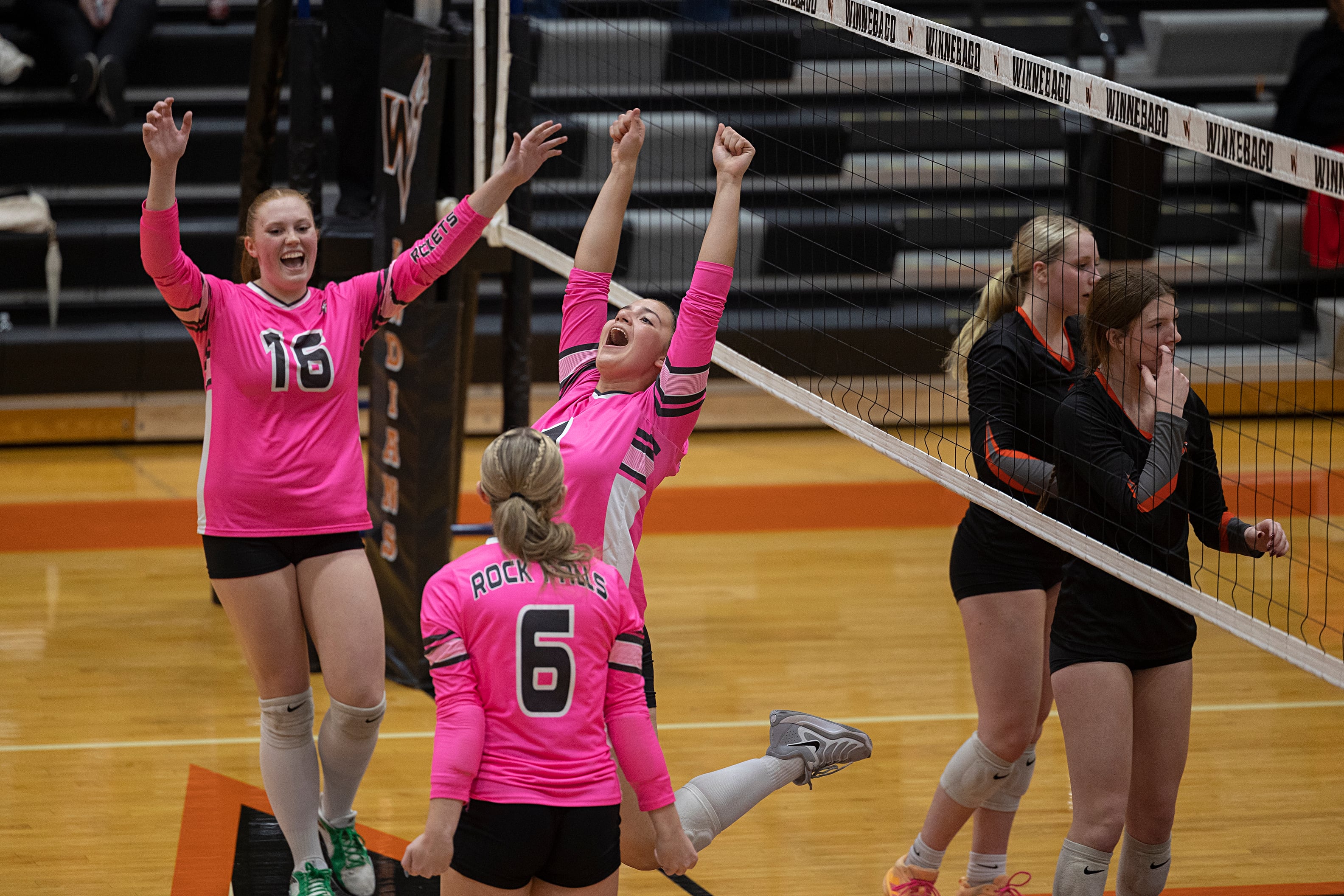 Rock Falls Rockets volleyball team celebrates a regional victory over Sandwich Indians.